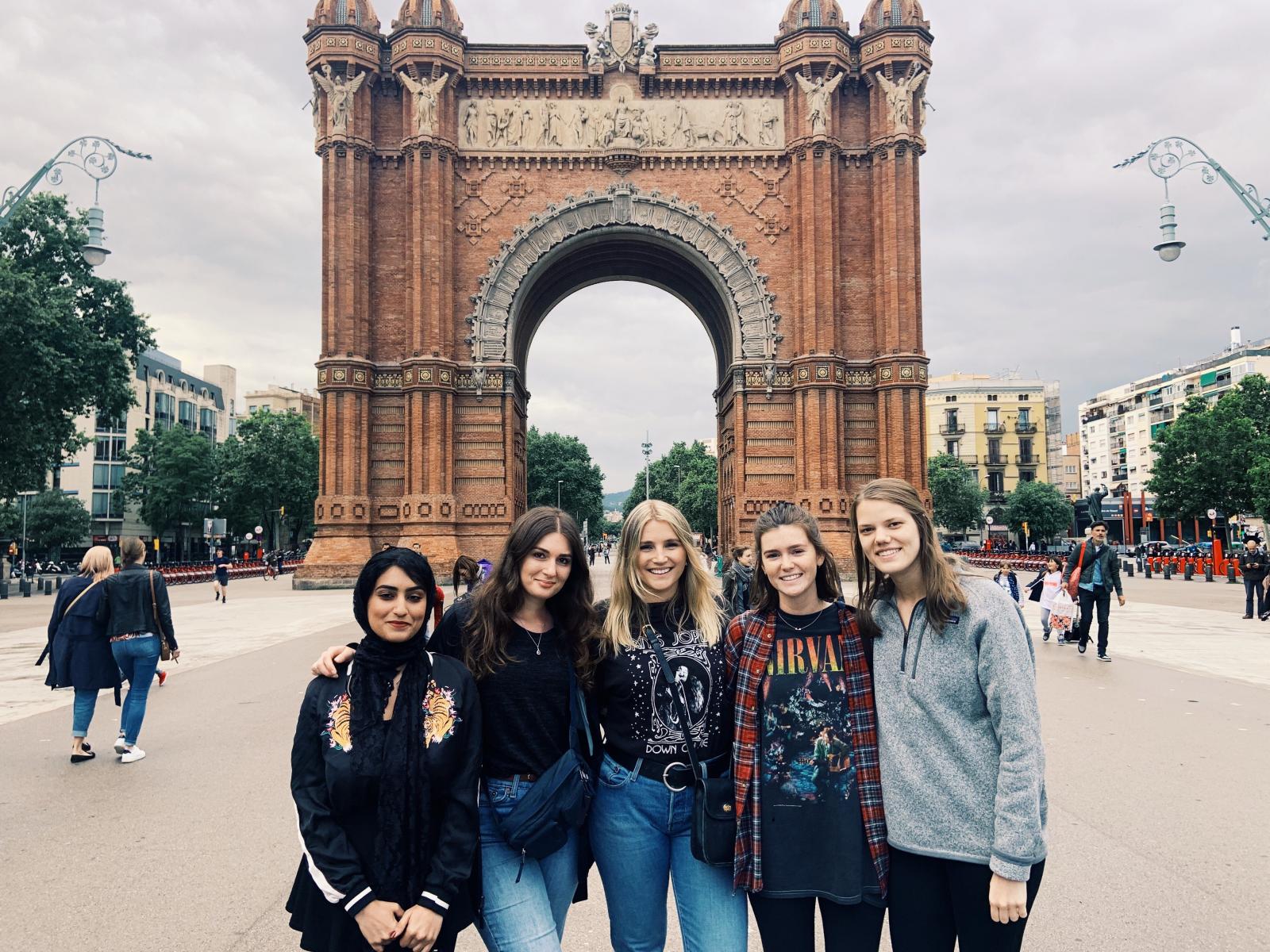 Group of girls outside in front of the Arc de Triomf in Barcelona.